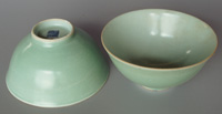 Jingdezhen celadon bowls, straight-rimmed and undecorated but for the potter's mark. Diameter 14cm.