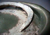 Celadon plate T-983 showing remains of tubular support stuck to the base.
